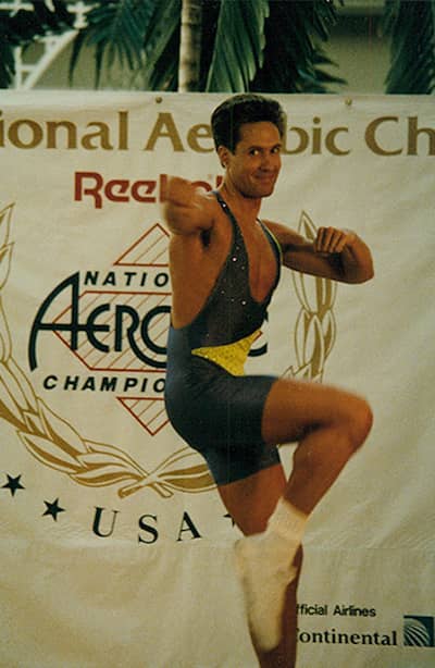 Keith does a gymnastic pose on one leg in a competition.