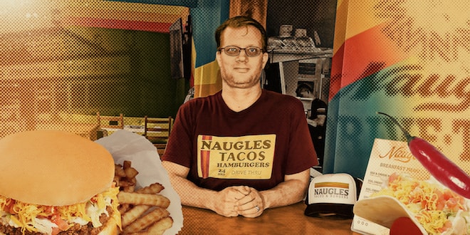 Christian Ziebarth is wearing a Naugles Taco Hamburgers shirt and flanked by a hamburger and a taco.