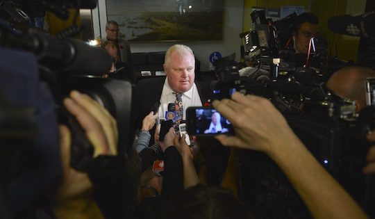 Mayor Rob Ford surrounded by cameras looming around him as he makes an announcement.