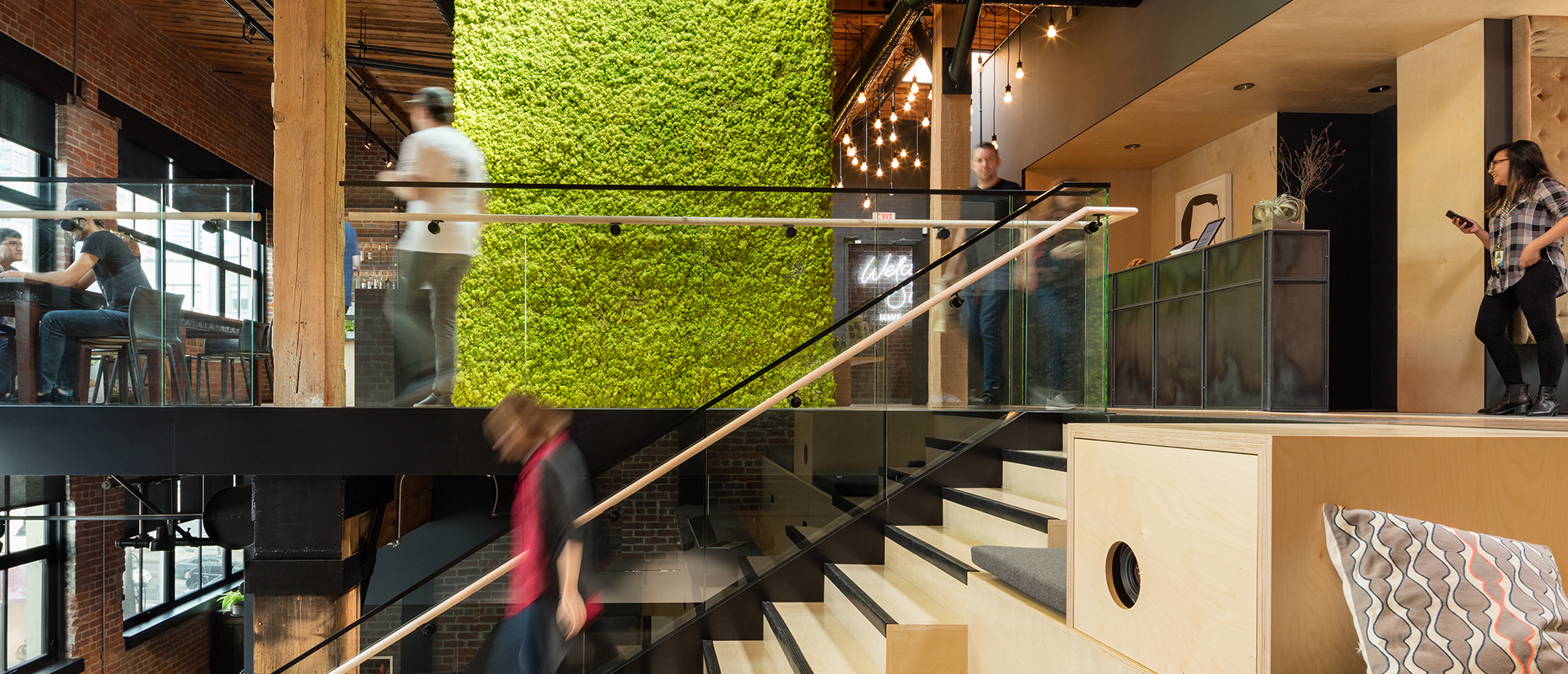 Slack office space with people walking around and smiling.