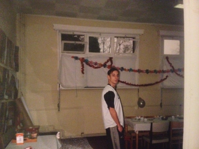 A young man in a rehab clinic looks towards the camera